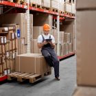 A man managing inventory in a warehouse.