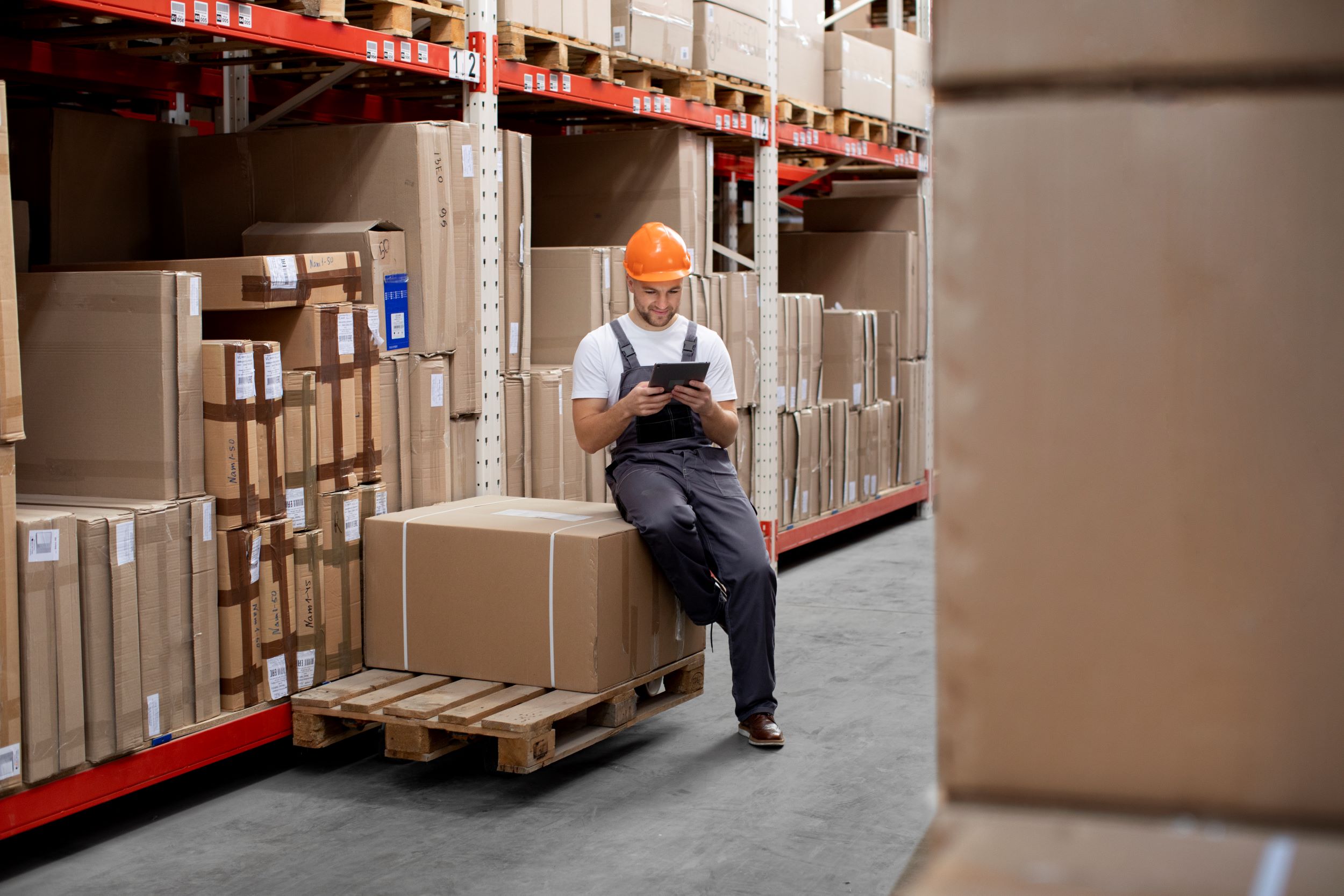 A man managing inventory in a warehouse.